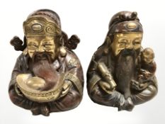 A pair of 20th century Chinese cast and patinated bronze figures of elders, height 23 cm.