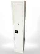 A metal gun cabinet, 30 cm x 28 cm x 150 cm.