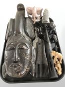 A group of African hardwood,resin and stone carvings including mask, combs and elephant figures.
