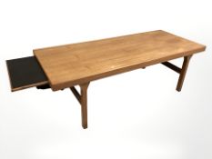 A Danish teak rectangular pull-out extending coffee table, unextended 160 cm x 65 cm x 51 cm.