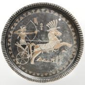 An Egyptian style patinated metal charger, diameter 59 cm.
