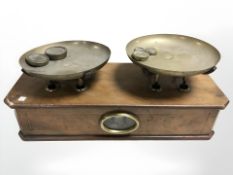 A set of Victorian walnut and brass scales with weights, width 44 cm.