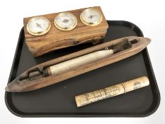 A combination barometer/thermometer/hygrometer, mounted on hardwood block,