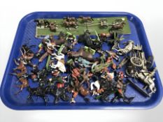 A group of die cast metal and plastic model soldiers, horse drawn cannon on carriage,