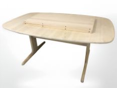 A Danish extending dining table with two leaves,