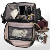 A camera bag containing Kodak Retina Reflex S camera, numbered 80633, and various accessories.