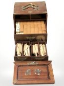 An oriental hardwood and brass mounted Mahjong set.