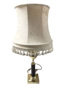 A brass table lamp with tasseled shade,