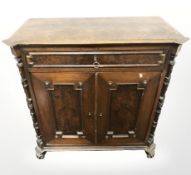 A continental carved walnut double door side cabinet, 79 cm x 40 cm x 79 cm.