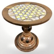 A circular walnut and butterfly wing chess board table, diameter 58 cm.