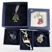A group of Swarovski crystal Christmas ornaments, all boxed.