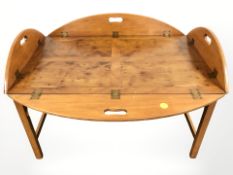 A yew wood butler's tray table, width 96 cm.