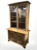 An early 20th century continental carved oak bookcase, 122 cm x 54 cm x 205 cm.