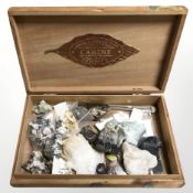 A cigar box containing gemstone specimens and minerals.
