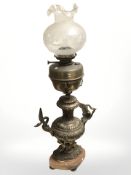 A Victorian brass oil lamp on associated decorative gilt metal twin handled stand, height 90 cm.