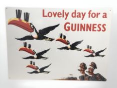 A reproduction Guinness tin sign, 70 cm x 50 cm.