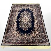 A machine made rug of Persian design,