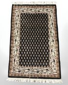 An Iranian rug on black ground, 100 cm x 59 cm.