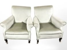 A pair of Edwardian library armchairs in pale green dralon upholstery,