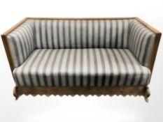 A late 19th century continental oak and metal bound hall settee with cast iron bow handles,