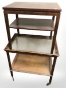 A mahogany glass topped two tier trolley,