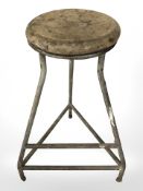 An industrial enamelled metal tripod stool
