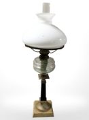 A brass and glass oil lamp, height 71 cm.