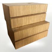 A pair of teak veneered two drawer chests, each 40 cm wide.