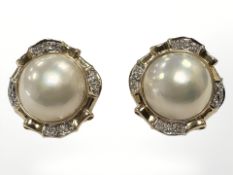 A pair of 18ct gold and diamond mabe pearl earrings, each 22mm diameter.