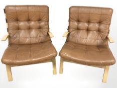 A pair of Danish bentwood and stitched tan leather lounge armchairs