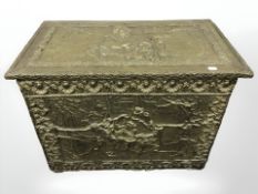 A continental embossed brass log box, width 70 cm.