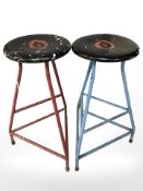 A pair of industrial enameled metal stools.