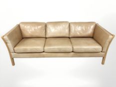 A late 20th century Danish tan leather three seater settee,