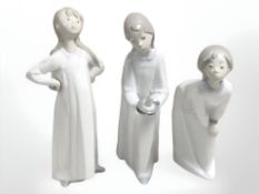 Three Lladro figures of children in night dress, tallest 20.5 cm.