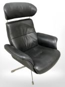 A Danish stitched charcoal leather armchair on metal support,