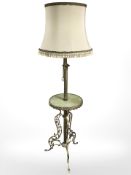 A gilt metal and onyx standing lamp incorporating a table.