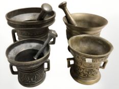 Four bronze mortars and pestles, tallest 13 cm.