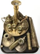 Brass wares including a large ejector chamber stick, further candlesticks, inert ammunition shell,