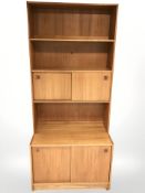 A Danish teak open bookcase with sliding cupboard doors, 89 cm x 50 cm x 200 cm.