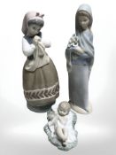 Two Lladro figures of ladies and a further of a baby girl, tallest 23 cm.