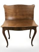 A 19th century mahogany serpentine front turnover top tea table, width 92 cm.