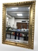 A gilt bevelled mirror, 84 cm x 63 cm.