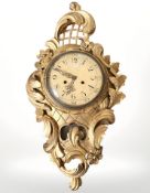 An early 20th century continental gilt gesso cartel wall clock, with pendulum, striking on a bell,
