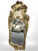 An ornate gilt composition mirror, height 107 cm.