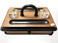 An Art Deco ebonised desk stand with two glass inkwells, width 33 cm.