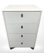 A white MDF four drawer chest, 56 cm x 46 cm x 90 cm.