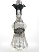 An Edward VII silver-mounted decanter, London 1908, height 26cm, and a silver sherry label.