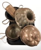 A group of antique copper jelly moulds, cheese grater, etc.