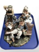 Three Capodimonte bisque porcelain figures including tramp and cobbler.
