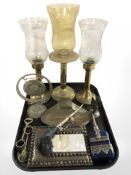Three brass candlesticks with etched glass shades, together with a decorative pipe,